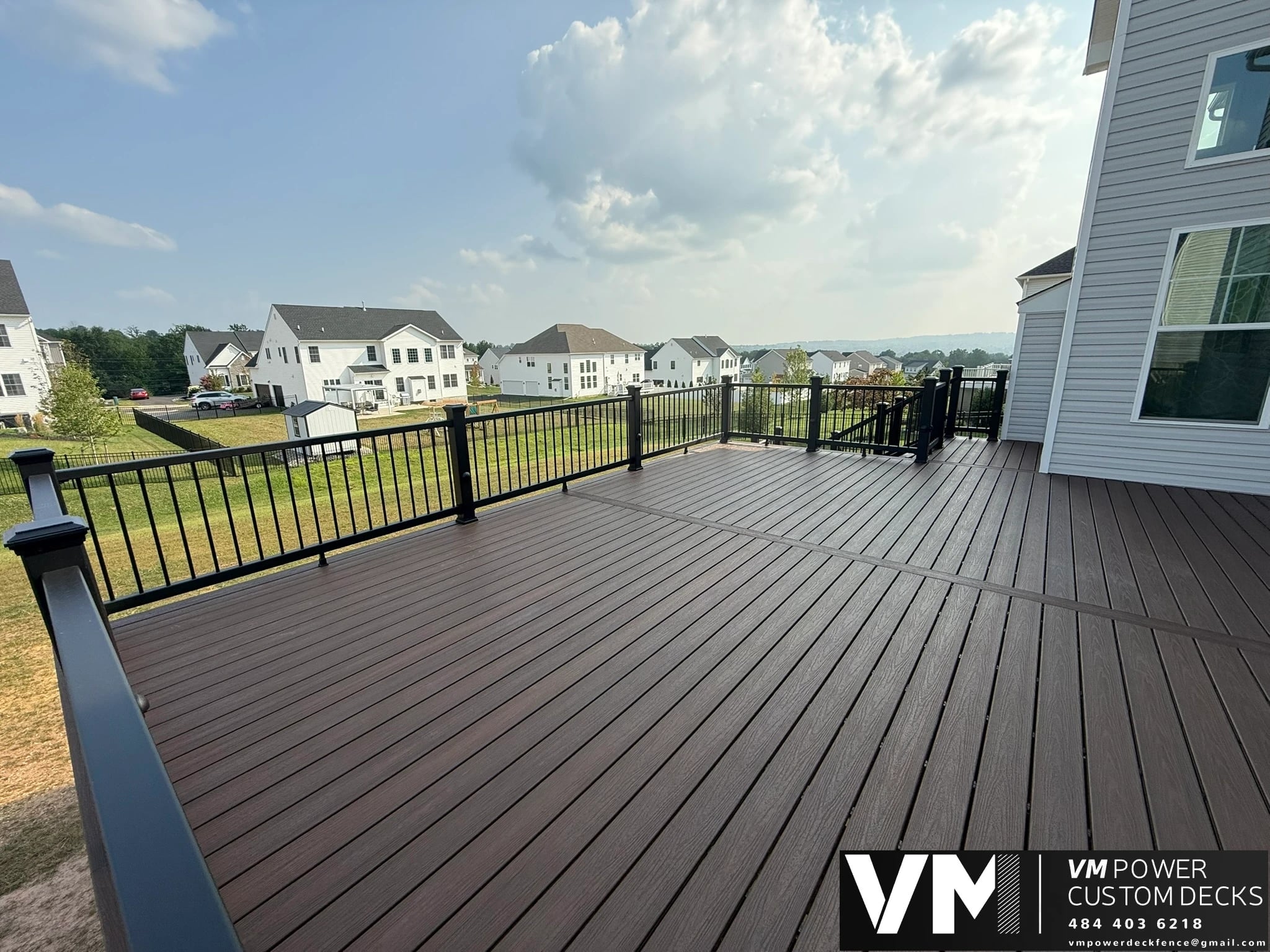 Completed composite deck in Center Valley with black aluminum railing and a picture-framed deck border